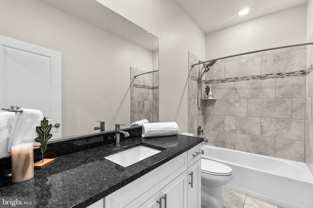 full bathroom with tiled shower / bath, vanity, toilet, and tile patterned flooring