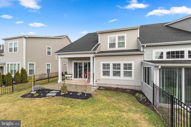 rear view of property featuring a yard and a patio