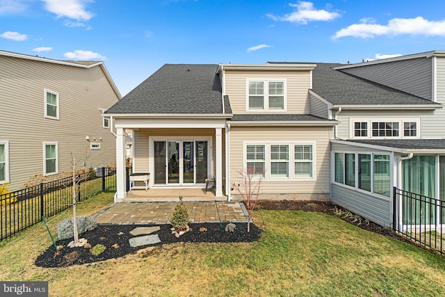 rear view of house with a lawn and a patio area