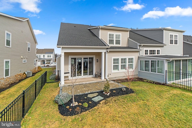 rear view of house featuring cooling unit, a yard, and a patio area