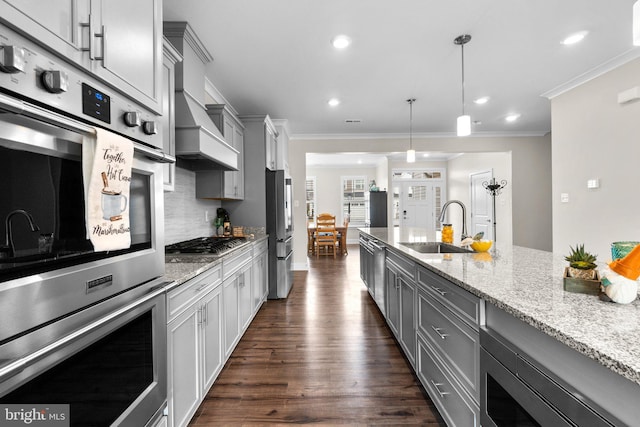 kitchen featuring sink, appliances with stainless steel finishes, gray cabinetry, light stone counters, and decorative light fixtures