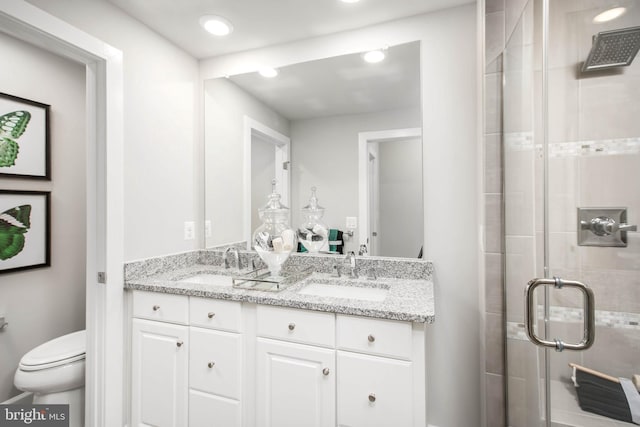 bathroom featuring walk in shower, vanity, and toilet