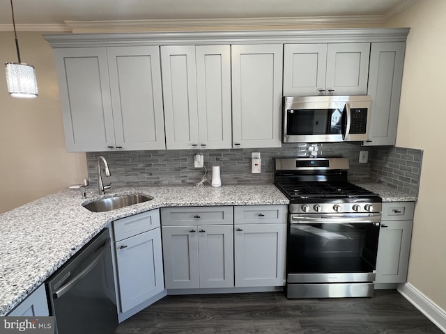 kitchen with pendant lighting, sink, stainless steel appliances, dark hardwood / wood-style floors, and ornamental molding