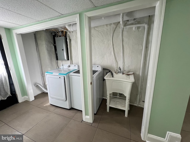 washroom featuring light tile patterned floors, electric panel, and washing machine and dryer