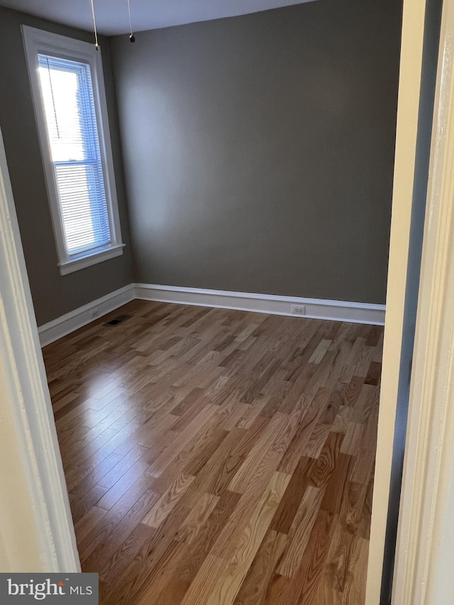 empty room with wood-type flooring