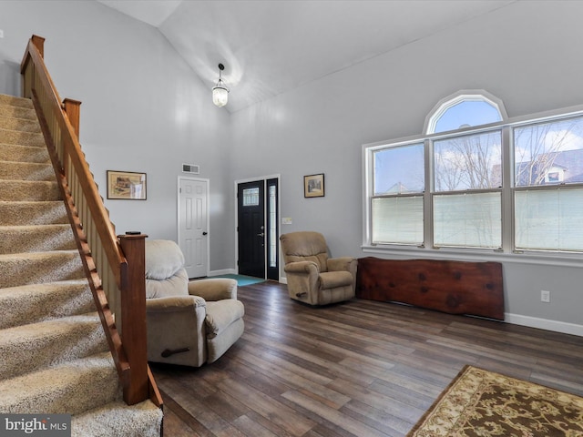 living room with high vaulted ceiling and dark hardwood / wood-style flooring