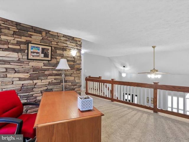 carpeted office featuring vaulted ceiling and ceiling fan