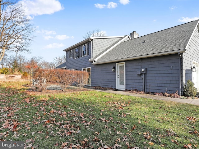 rear view of house featuring a yard