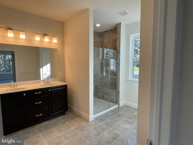 bathroom featuring walk in shower, tile patterned floors, and vanity