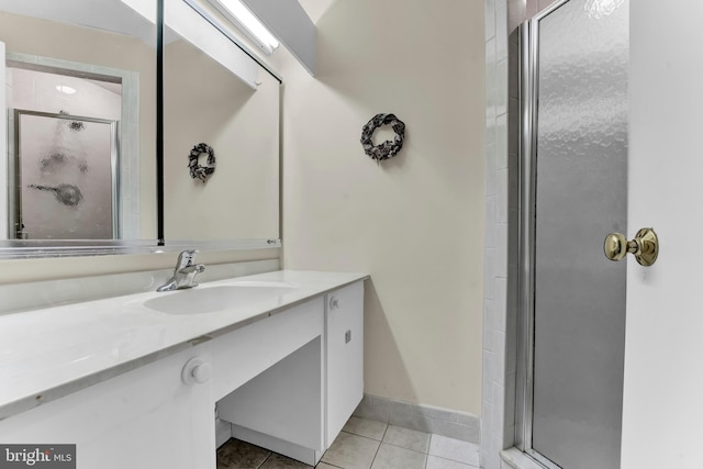 bathroom with vanity, a shower with shower door, and tile patterned flooring