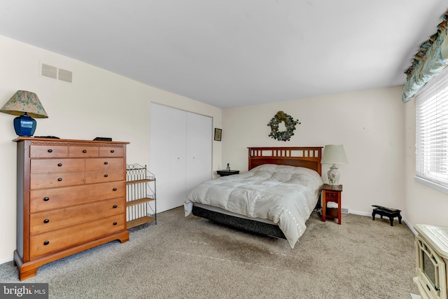 carpeted bedroom featuring a closet