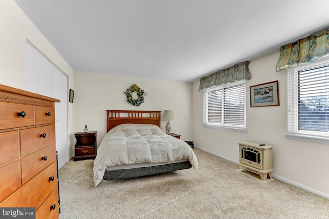 bedroom with multiple windows and light colored carpet