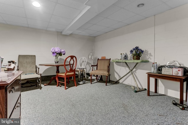 sitting room featuring a paneled ceiling and carpet floors