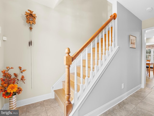 stairway with tile patterned flooring