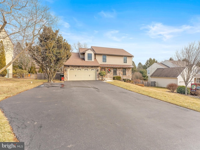 view of front of house with a garage and a front lawn