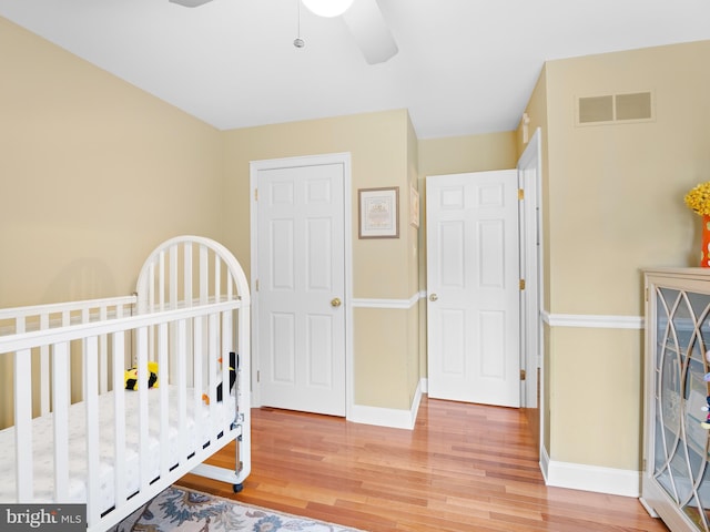 bedroom with hardwood / wood-style floors and ceiling fan