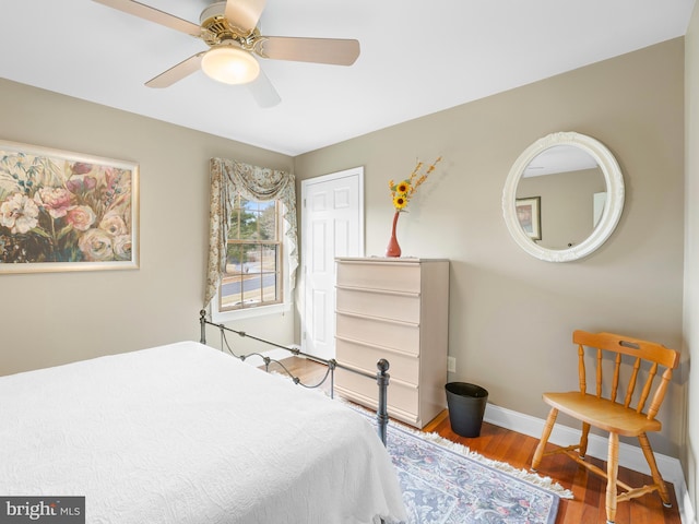 bedroom featuring hardwood / wood-style flooring, a closet, and ceiling fan