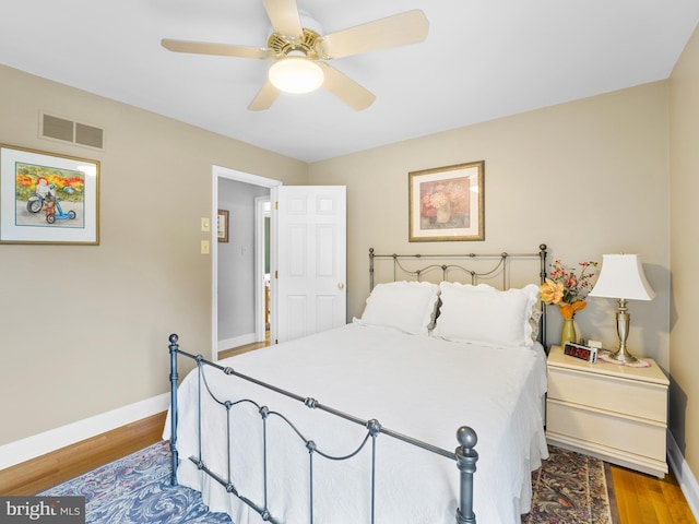 bedroom with hardwood / wood-style floors and ceiling fan