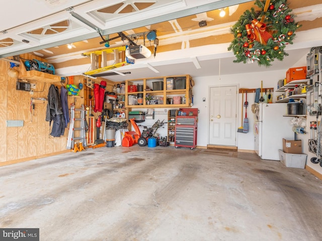 garage with a garage door opener and a workshop area