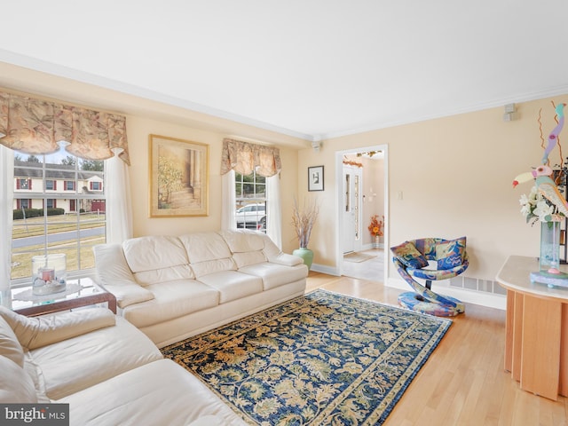 living room featuring light hardwood / wood-style flooring and ornamental molding