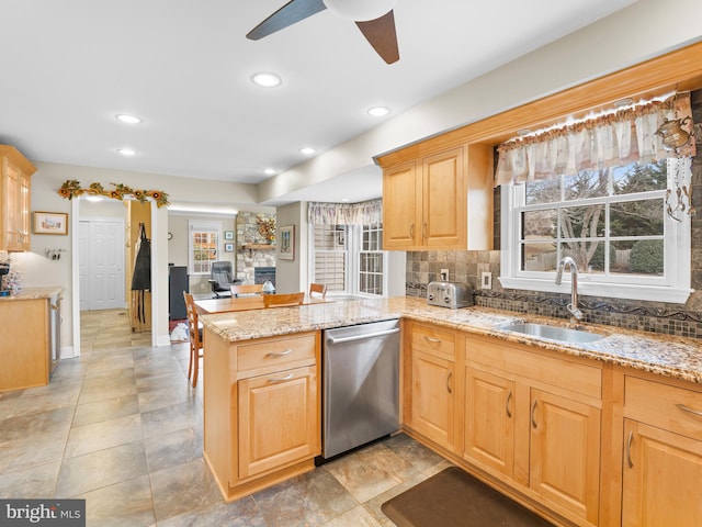 kitchen with sink, dishwasher, tasteful backsplash, light brown cabinetry, and kitchen peninsula