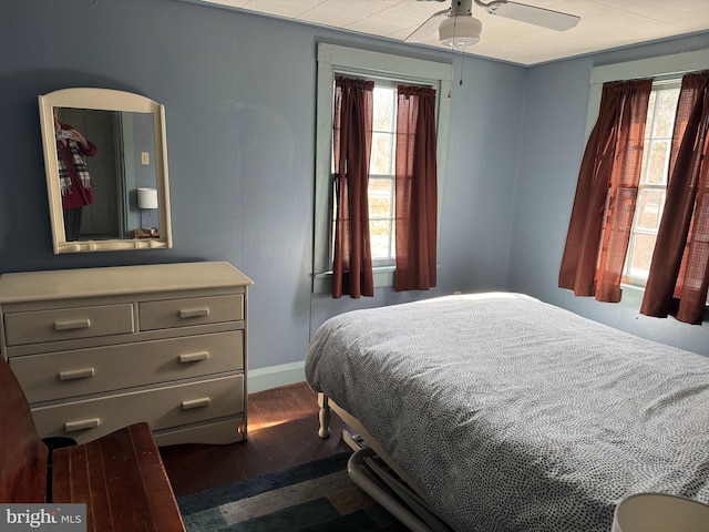 bedroom with dark wood-type flooring and ceiling fan