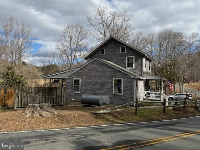 view of side of property featuring covered porch