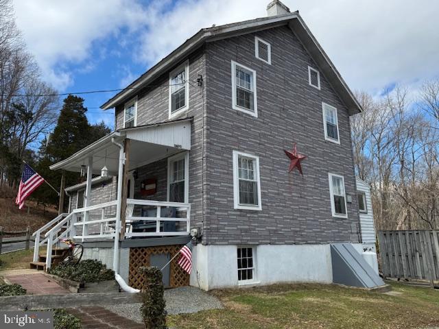 view of side of home featuring a yard