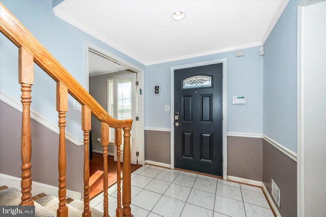 foyer entrance with stairs, baseboards, visible vents, and crown molding