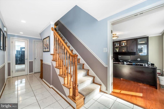 stairway with baseboards, ornamental molding, and recessed lighting