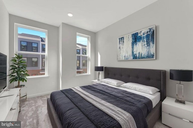 bedroom featuring multiple windows and light carpet