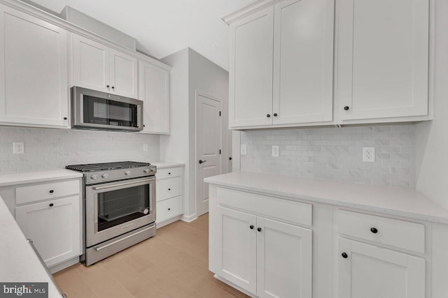 kitchen featuring light hardwood / wood-style floors, white cabinets, and appliances with stainless steel finishes