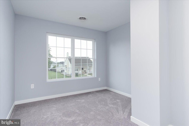 unfurnished room featuring light colored carpet