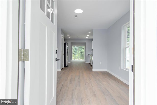 corridor with light wood-type flooring