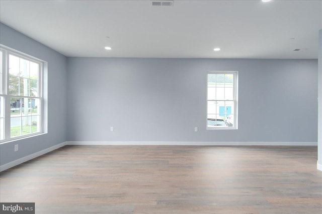 unfurnished room with light wood-type flooring