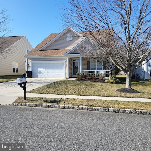 view of front of house featuring a garage, a porch, and a front lawn