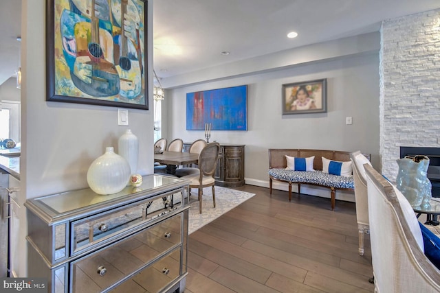 interior space with a stone fireplace and hardwood / wood-style floors