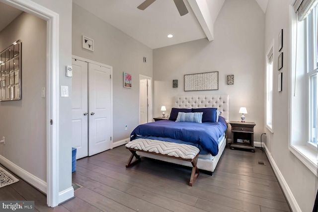 bedroom featuring multiple windows, hardwood / wood-style floors, and ceiling fan