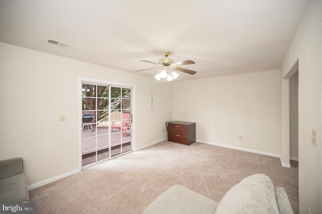 empty room with light colored carpet and ceiling fan