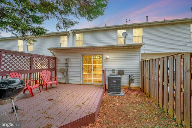 deck at dusk featuring cooling unit