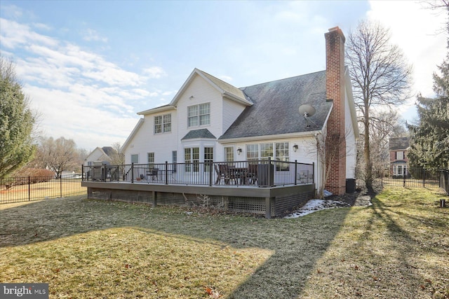 back of house featuring fence private yard, a chimney, a deck, and a yard