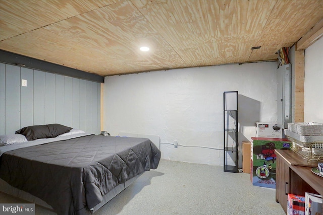 bedroom featuring electric panel and wood ceiling