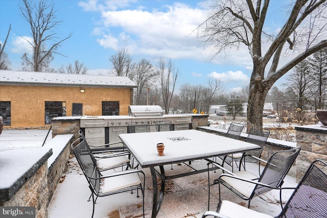 view of patio with outdoor dining space, grilling area, and an outdoor kitchen