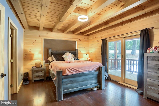 bedroom featuring wooden walls, dark wood-style flooring, and access to outside