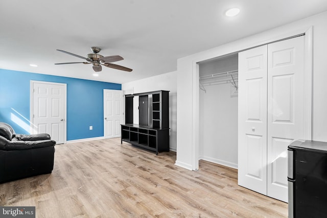 interior space featuring ceiling fan, recessed lighting, baseboards, light wood-style floors, and fridge