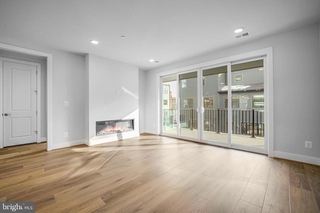 unfurnished living room featuring light wood-type flooring