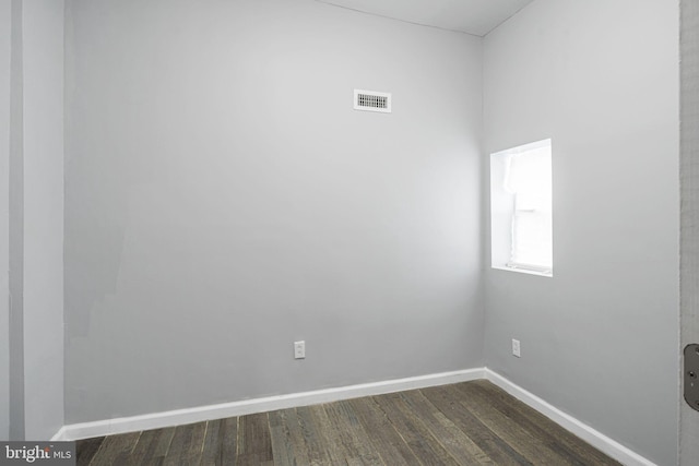 empty room with dark hardwood / wood-style flooring