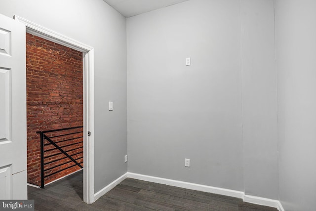 spare room featuring dark wood-type flooring