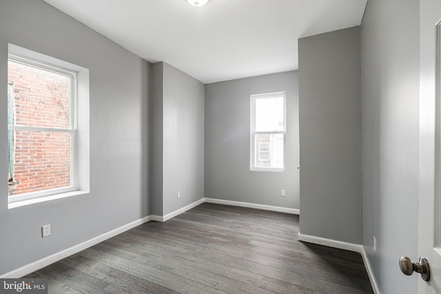 spare room with dark wood-type flooring