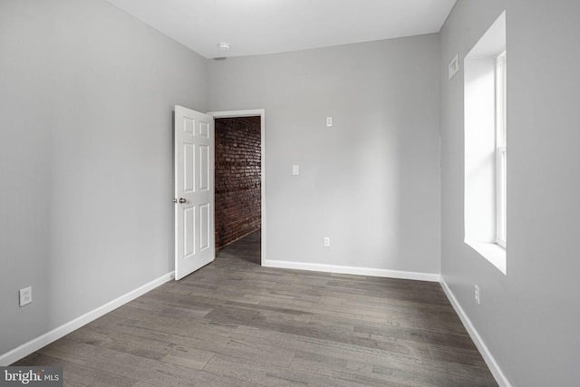 unfurnished room featuring hardwood / wood-style flooring